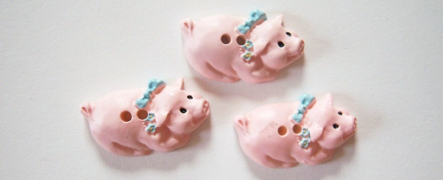 Blue ribbon on neck of pink pig 5/8" x 1" two hole clay button.
