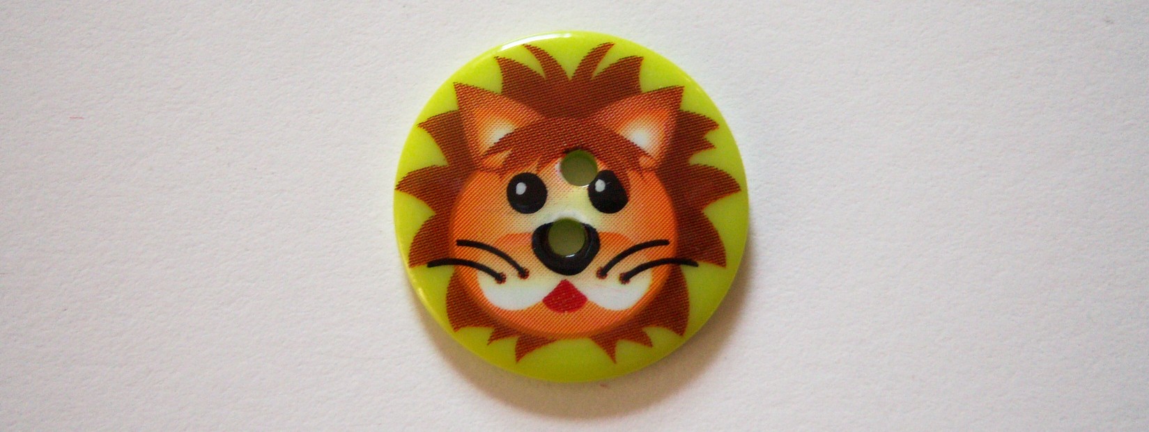 JHB Critter lion face 1" on shiny lime poly 2 hole button.