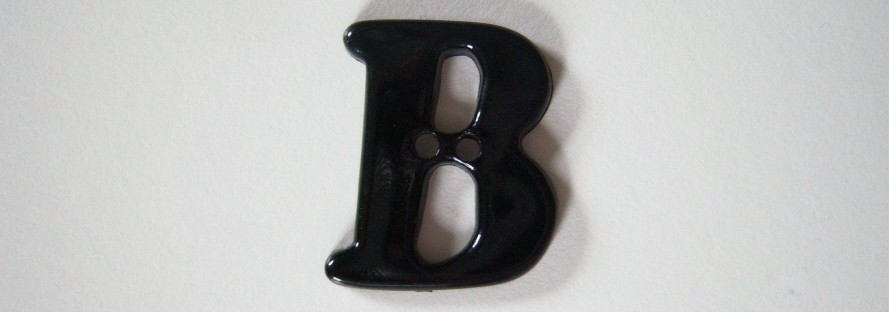 Black letter В 1 1/8" with 2 holes poly button.