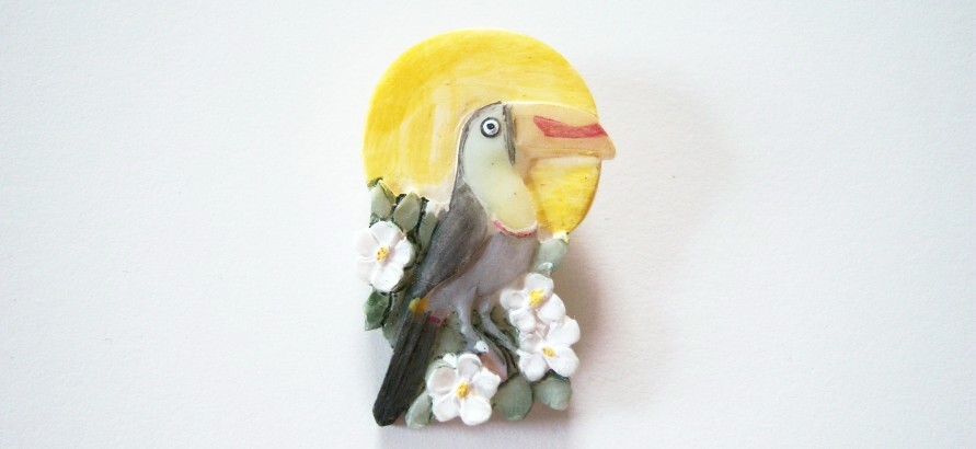 Sun toucan white flowers 1" x 1 1/2" shank back clay button.